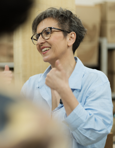 Nancy Oliveira talking with founders on a factory floor